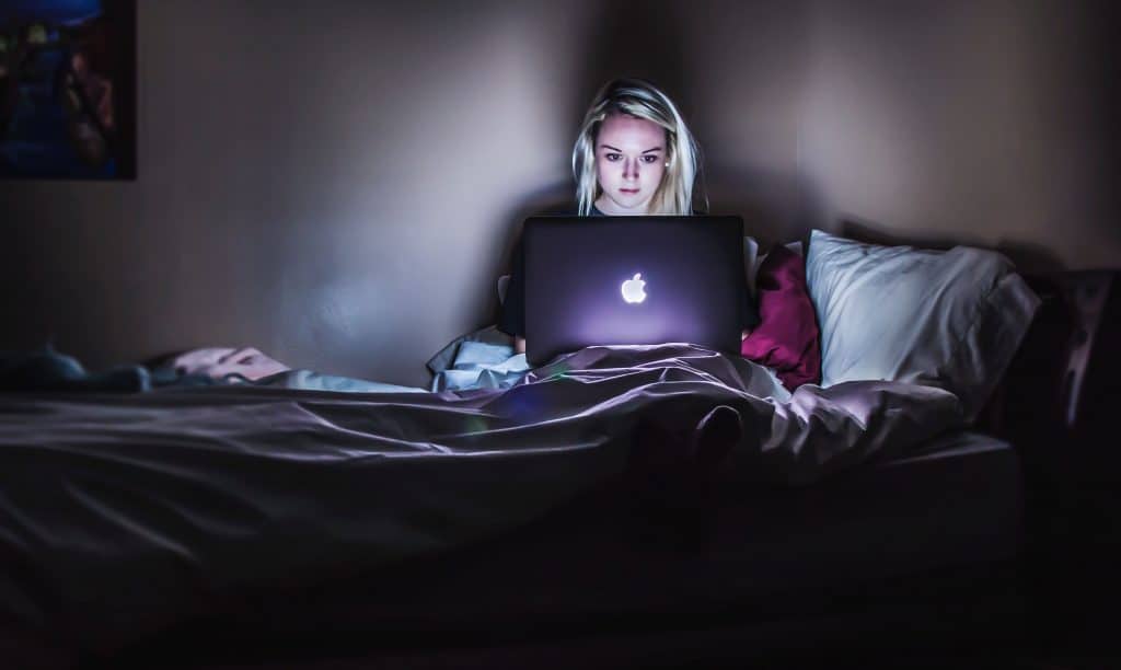 Woman receiving counseling on a laptop.