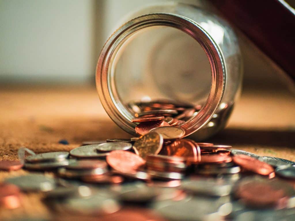 Pennies falling out of a jar.