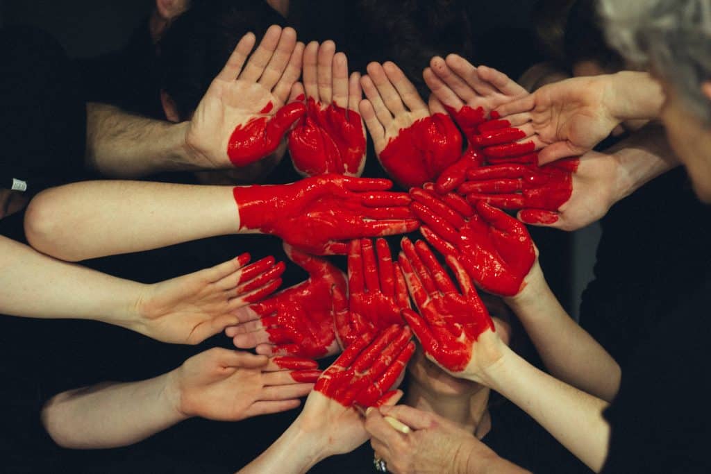 People making a heart symbol with their hands.