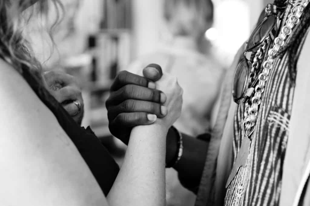 Two women holding hands.