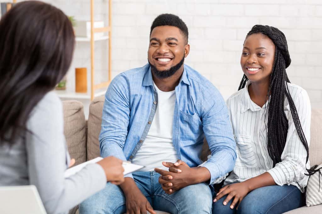 Couple speaking with a counselor.