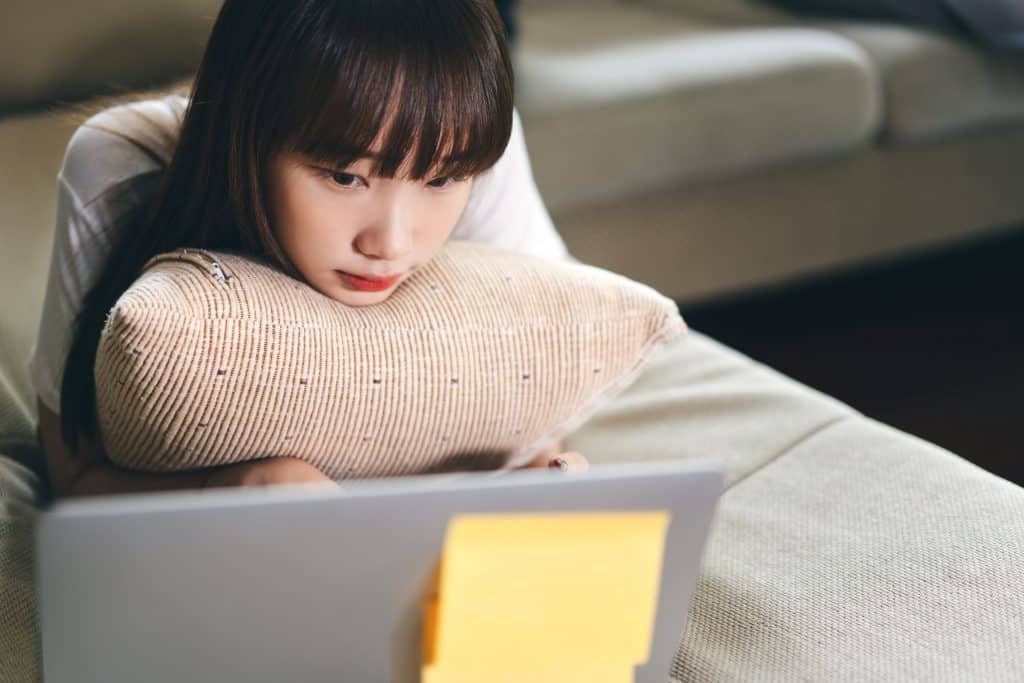 Woman receiving therapy on a laptop.