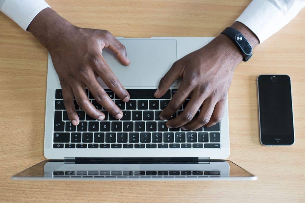 Man typing an email.