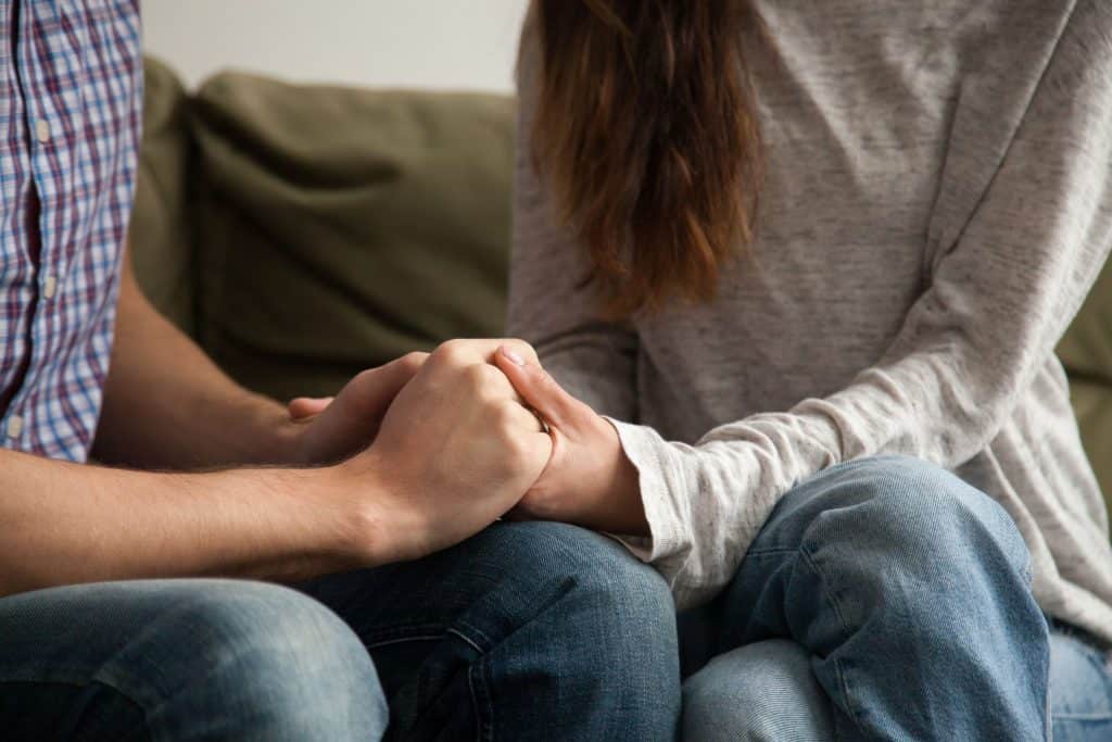 Couple holding hands.