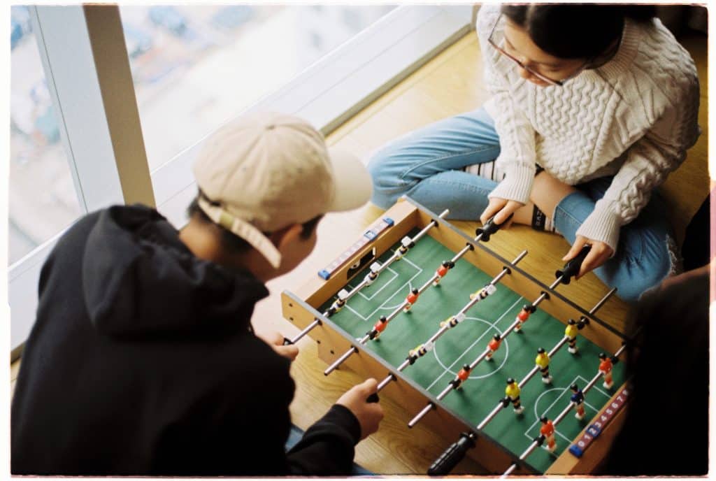 Couple playing foosball.