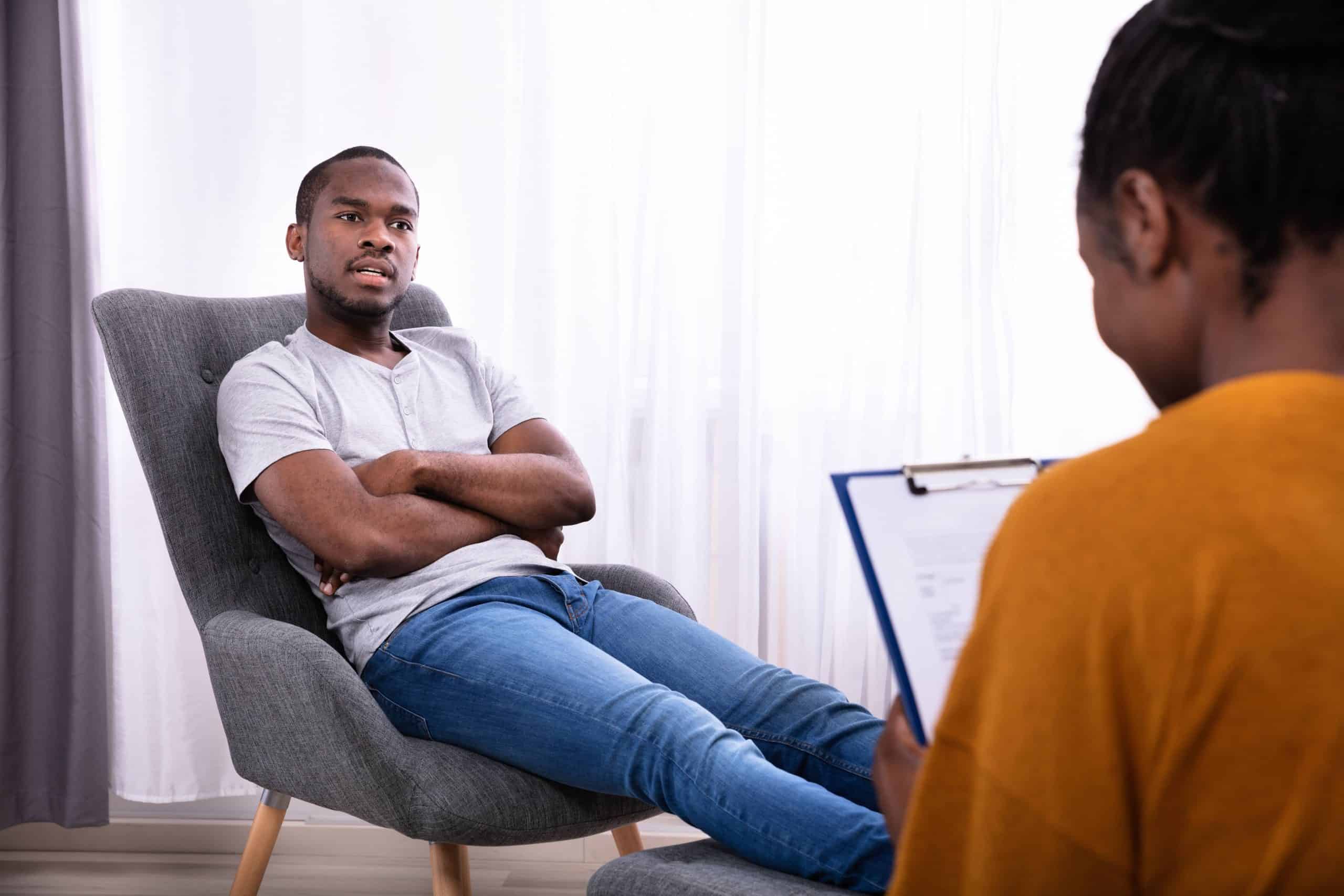 Black man speaking with a black therapist.