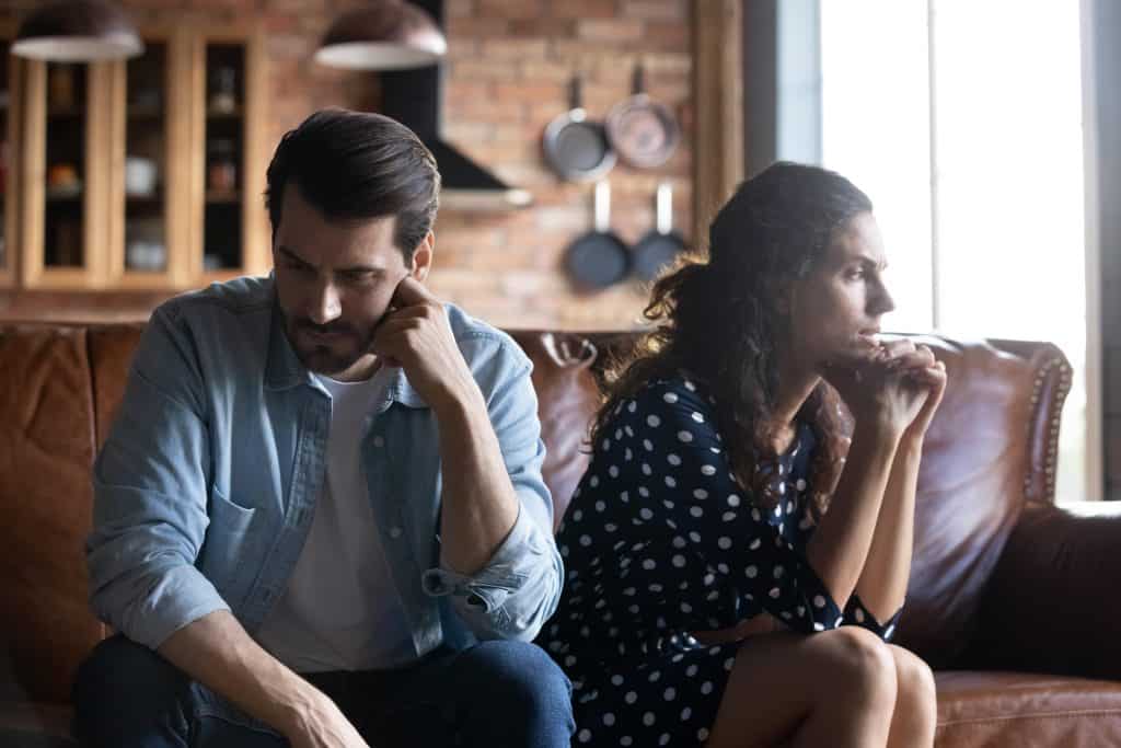 Hispanic couple speaking with a marriage counselor.