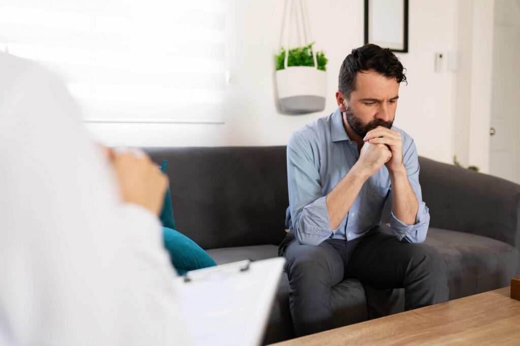 Man speaking to an LGBT affirming counselor.